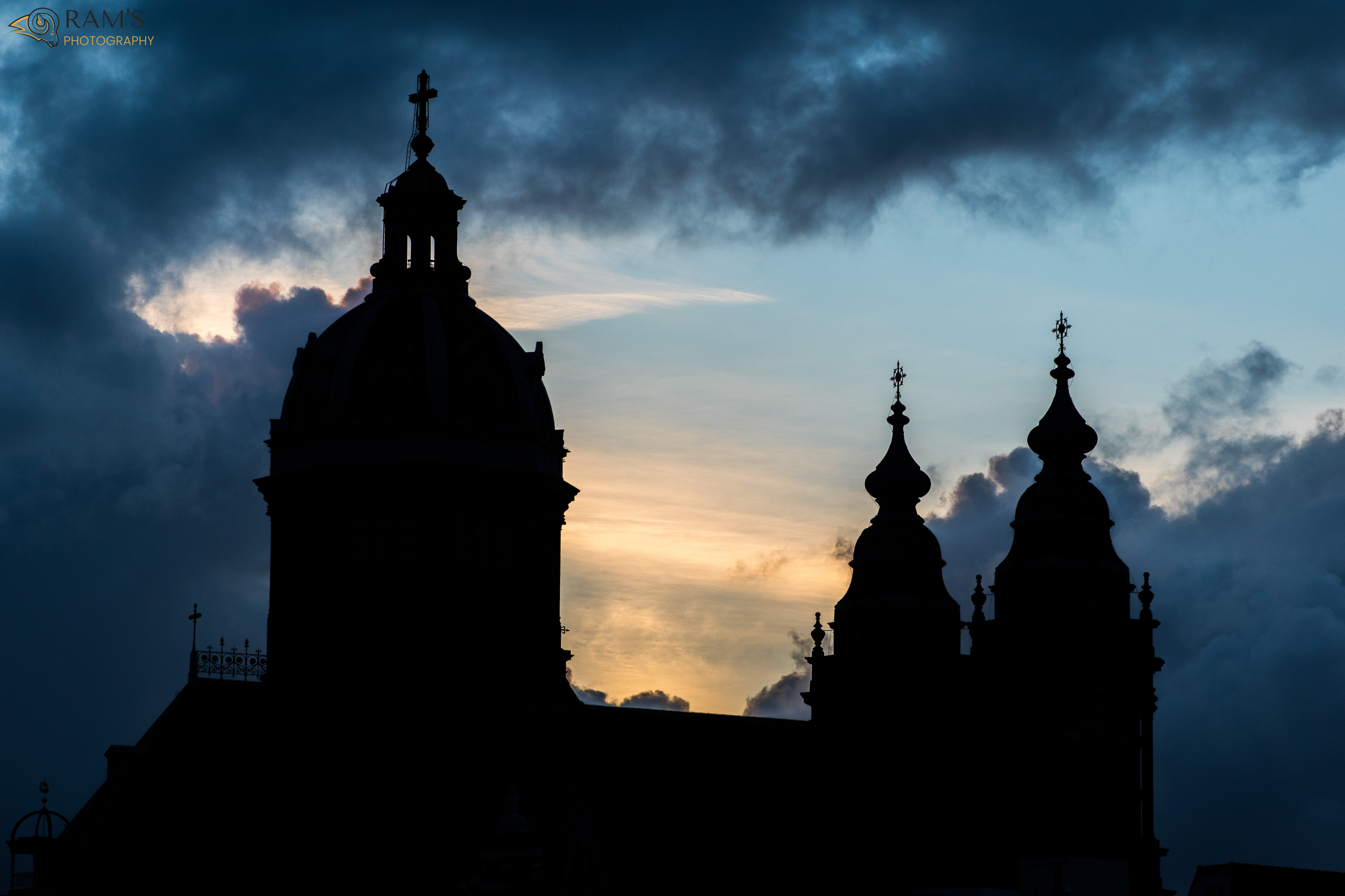 silhouette of buildings in a cloudy sunset in amsterdam